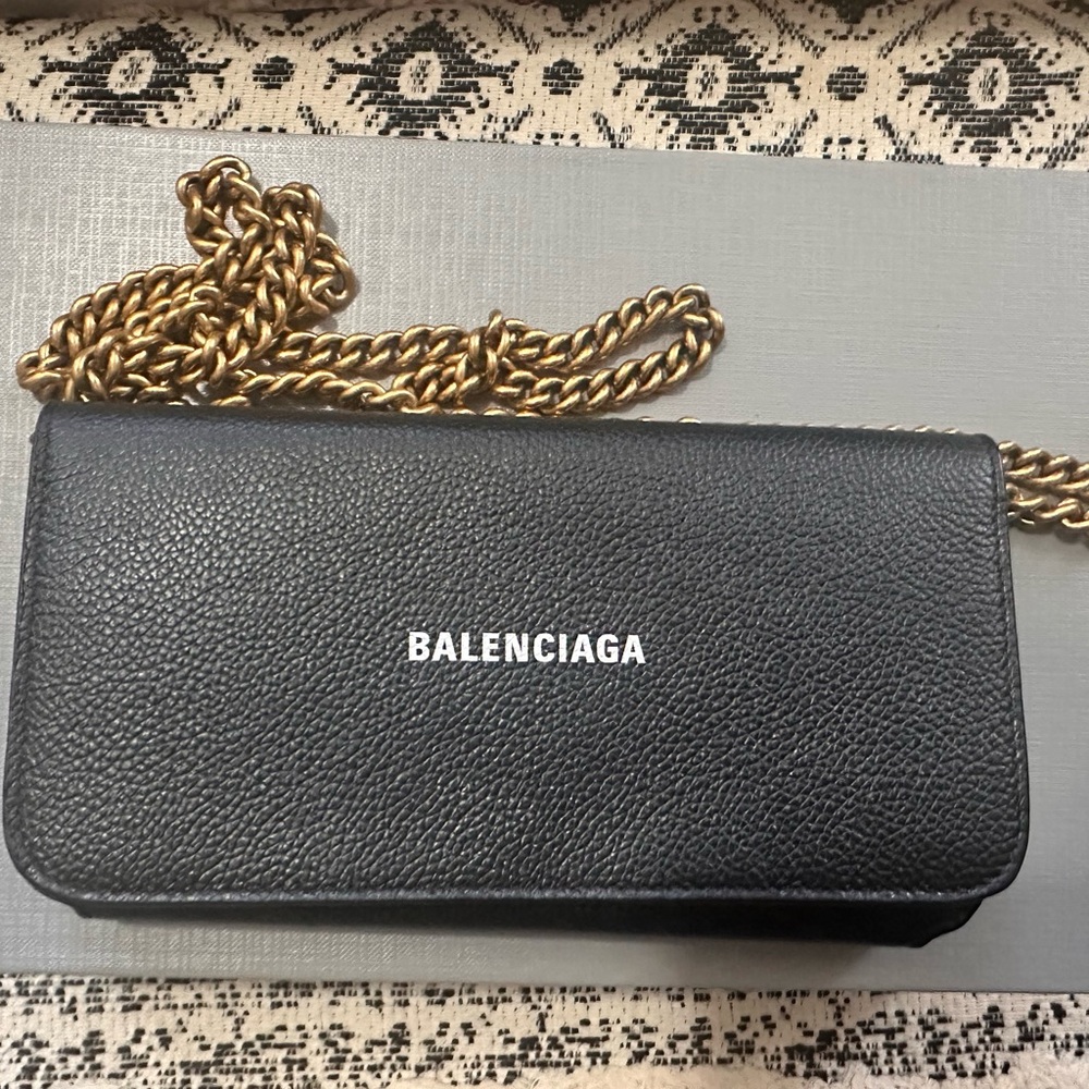 Authentic Balenciaga logo wallet on chain in black.